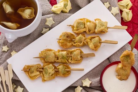 Espetinhos de tortellini fritos com molho de creme de leite e parmesão