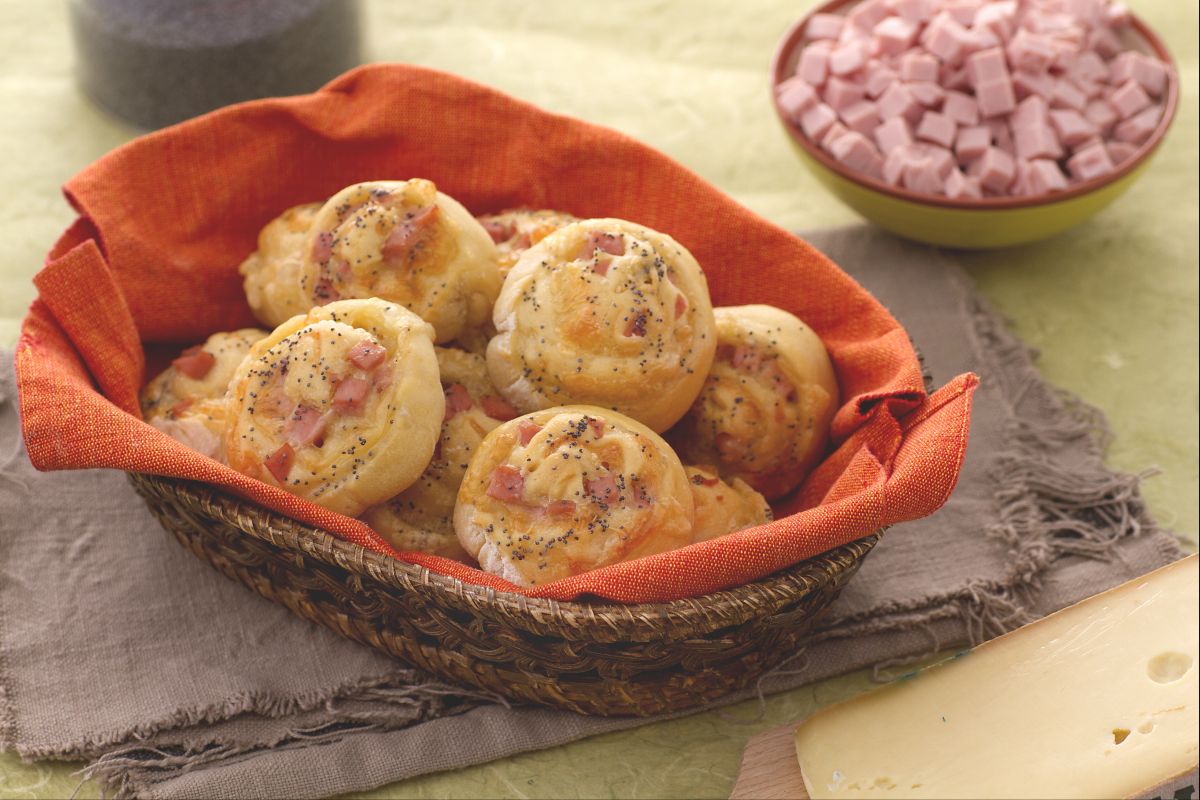 Caracóis de pão recheados com cubos de presunto e queijo fontina