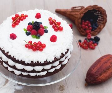 Bolo de camadas de chocolate com creme de leite e frutas vermelhas